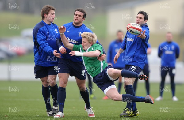 31.01.11 - Wales Rugby Training - Ben John of Wales under 20s is tackled by Jonathan Davies, Jamie Roberts and Stephen Jones during training. 