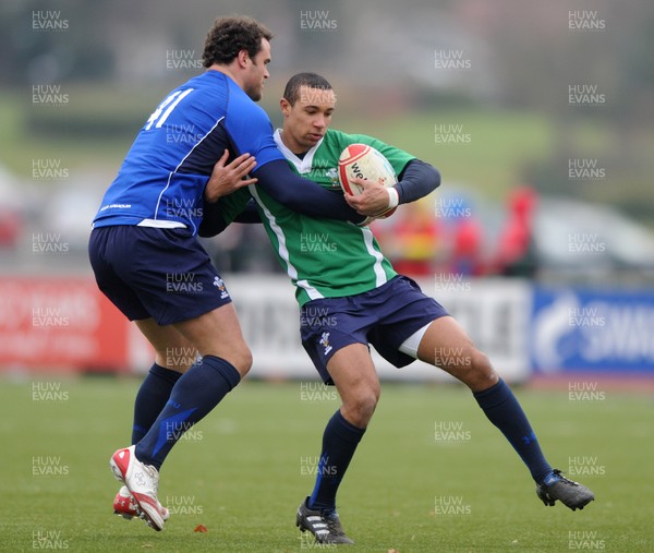 31.01.11 - Wales Rugby Training - Eli Walker of Wales under 20 is tackled by Jamie Roberts during training. 