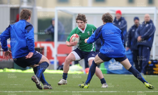 31.01.11 - Wales Rugby Training - Harry Robinson of Wales under 20 takes on Jonathan Davies and Leigh Halfpenny during training. 