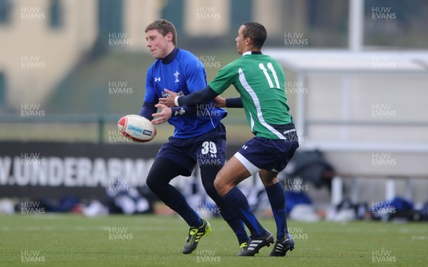31.01.11 - Wales Rugby Training - Rhys Priestland is tackled by Eli Walker of Wales under 20s during training. 