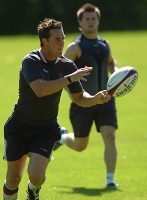 31.07.07 - Wales Rugby Training - Lee Byrne during training as Ceri Sweeney follows 