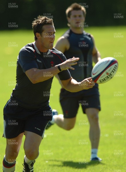 31.07.07 - Wales Rugby Training - Lee Byrne during training as Ceri Sweeney follows 