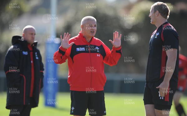 03.09.11 - Wales Rugby Training - Head coach Warren Gatland talks to Bradley Davies during training. 