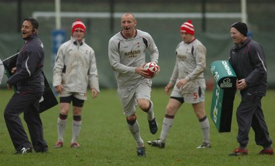 14.11.06 - Wales Rugby Press Conf. - New Wales Captain, Gareth Thomas gets through Nigel Davies(L) and Neil Jenkins(R) 