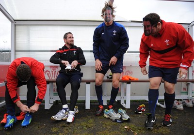 29.11.11 - Wales Rugby Training  Shane Williams puts his boots on as George North, Liam Williams and Ryan Bevington wear masks with his face on after he was named in the Wales team to play Australia, which will be his last game for his country before he retires from international rugby. 