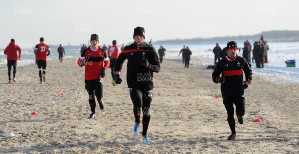 27.01.12 - Wales Rugby Training Camp in Poland - Scott Williams, Alex Cuthbert and Leigh Halfpenny during fitness training on the beach. 