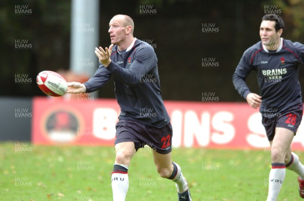 31.10.06  Wales rugby training, Cardiff  Former Wales captain Gareth Thomas passes watched by new captain Stephen Jones.  