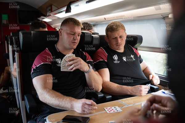 051023 - Wales Rugby travel to Nantes from Paris ahead of their final Rugby World Cup Pool game against Georgia - Dewi Lake and Jac Morgan play cards on the train