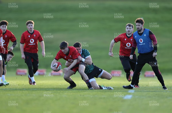 260124 - Wales Rugby Training against the U20s team - Kodi Stone is tackled by Owen Watkin