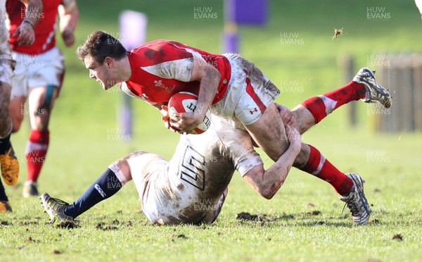 170313 - Wales Students v England Students, Clifton RFC - Wales' Matthew Smith looks to release the ball as he's tackled by England's Simon Hammersley