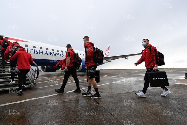 110321 - Wales Rugby team travel from Cardiff Airport to Italy ahead of this weekends Guinness 6 Nations match in Rome - Gareth Davies (right) and team mates board the plane