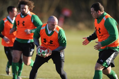 11.02.10 - Wales Rugby Training - Gareth Williams is supported by Adam Jones(L) and Paul James(R) during training. 