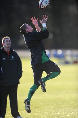 29.01.10 - Wales Rugby Training - Richie Rees takes high ball as attack coach Rob Howley looks on during training. 