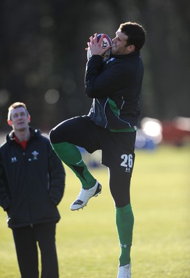 29.01.10 - Wales Rugby Training - Jamie Roberts takes high ball as attack coach Rob Howley looks on during training. 