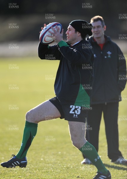 29.01.10 - Wales Rugby Training - Stephen Jones takes high ball as attack coach Rob Howley looks on during training. 