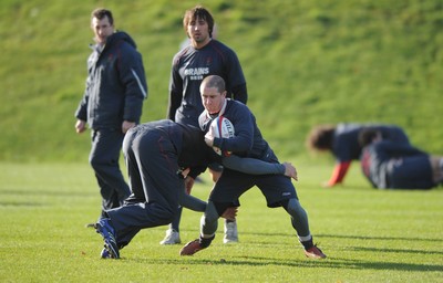 31.01.07 - Wales Rugby Training - Shane Williams is tackled by Lee Byrne during training 