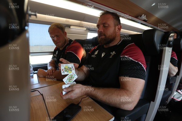 070923 - The Wales Rugby Travel from Paris to Bordeaux on the train ahead of their opening Rugby World Cup game -  Corey Domachowski and Henry Thomas enjoy a game of cards