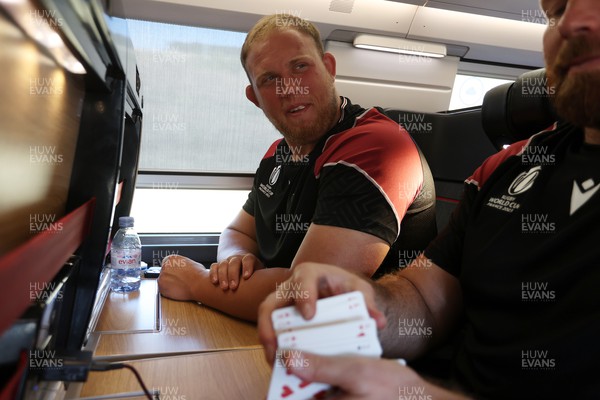 070923 - The Wales Rugby Travel from Paris to Bordeaux on the train ahead of their opening Rugby World Cup game -  Corey Domachowski and Henry Thomas enjoy a game of cards