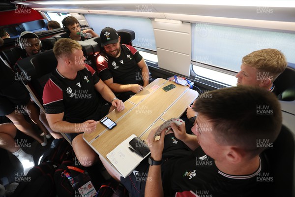 070923 - The Wales Rugby Travel from Paris to Bordeaux on the train ahead of their opening Rugby World Cup game -  Dewi Lake, Nicky Smith, Adam Beard and Jac Morgan play cards