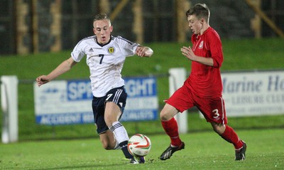 311013 - Wales v Scotland Under 16 Victory Shield International, Aberystwyth - Scotland's Calvin Miller and Wales' Rhys Abbruzzese compete for the ball