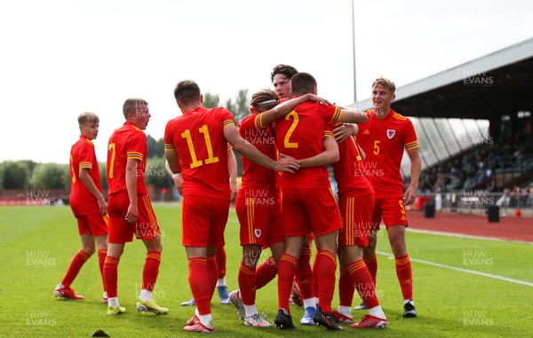 030921 - Wales U18 v England U18, International Friendly Match - Luke Harris of Wales is mobbed by team mates as he celebrates after he scores goal