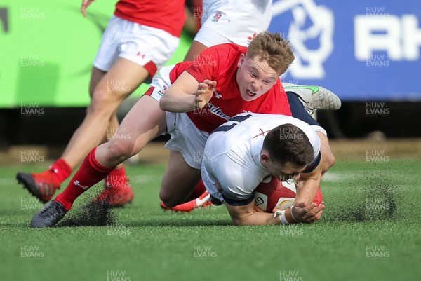 250318 - Wales U18 v England U18 - Jacob Morris of England is tackled by Sam Costelow of Wales