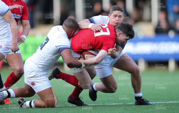 250318 - Wales U18 v England U18 - Osian Knott of Wales is tackled by Jack Reeves of England and Ollie Lawrence of England