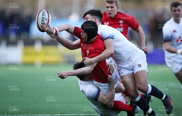 250318 - Wales U18 v England U18 - Ioan Davies of Wales releases the ball as he is tackled