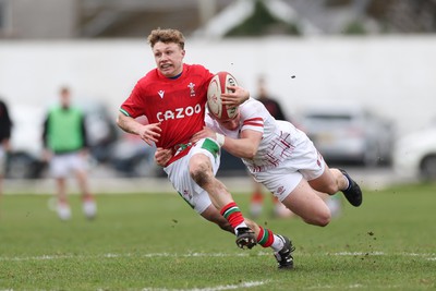 260323 - Wales U18 v England U18 - Tom Bowen of Wales is tackled by Frank McMillan of England