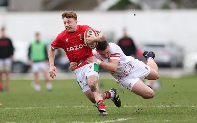 260323 - Wales U18 v England U18 - Tom Bowen of Wales is tackled by Frank McMillan of England