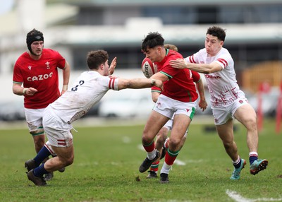 260323 - Wales U18 v England U18 - Elijah Evans of Wales is held by the England defence