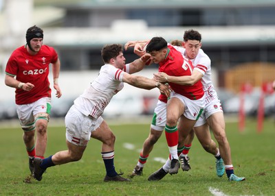 260323 - Wales U18 v England U18 - Elijah Evans of Wales is held by the England defence