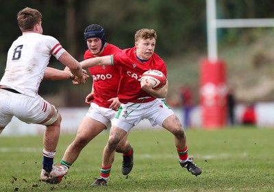 260323 - Wales U18 v England U18 - Tom Bowen of Walesgets past Reuben Logan of England