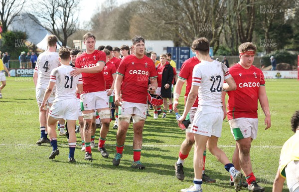 260323 - Wales U18 v England U18 - The Wales and England teams congratulate each other at the end of the match
