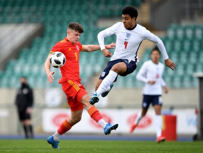 290321 - Wales U18 v England U18 - Under 18 International Match - Ryan Viggars of Wales is challenged by CJ Egan-Riley of England 