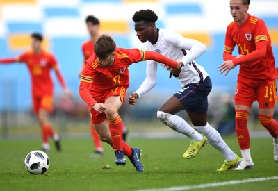 290321 - Wales U18 v England U18 - Under 18 International Match - Rio Dyer of Wales is tackled by Daniel Oyegoke of England