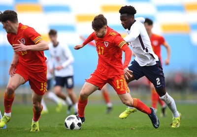 290321 - Wales U18 v England U18 - Under 18 International Match - Rio Dyer of Wales is tackled by Daniel Oyegoke of England