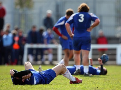 01.04.08 - Wales v France - Under 18 Six Nations 2008 - A dejected Sonny Falconetti of France lies on the ground after the final whistle with some of his team mates in the background  