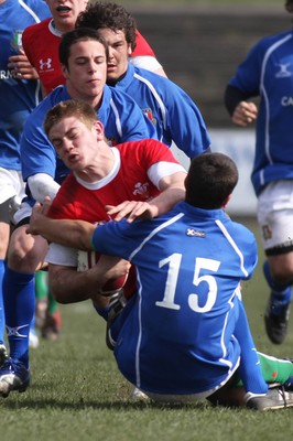 22.03.09 Wales vs. Italy. Under 18's 6 Nations. Rhodri Jones is brought to ground by the double tackle of Alessandro Tartaglia(15) & Luigi Secchi Villa. 