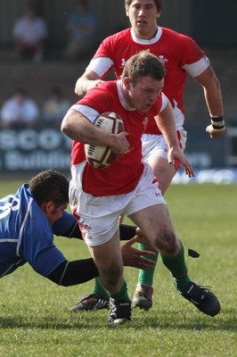 22.03.09 Wales vs. Italy. Under 18's 6 Nations. Gareth Harvey steps through the diving tackle of Guglielmo Palazzani. 