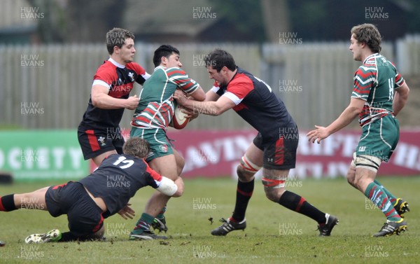 120213 - Wales U18 v Leicester Tigers Academy -   Pasqualle Dunn of Leicester, centre, is tackled by Craig Woodall (12) Joe Thomas, left and Dan Brookes of Wales