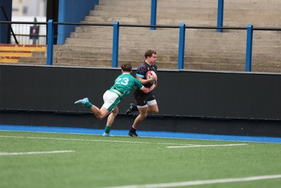 290326 - Wales U19 v Ireland U19 - Rhys Cole of Wales is tackled into touch by Fionn Rowsome of Ireland