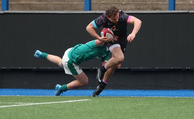 290326 - Wales U19 v Ireland U19 - Rhys Cole of Wales is tackled into touch by Fionn Rowsome of Ireland