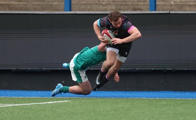 290326 - Wales U19 v Ireland U19 - Rhys Cole of Wales is tackled into touch by Fionn Rowsome of Ireland