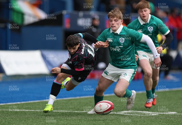 290326 - Wales U19 v Ireland U19 - Noah Morgan of Wales and Andrew Henson of Ireland compete for the ball