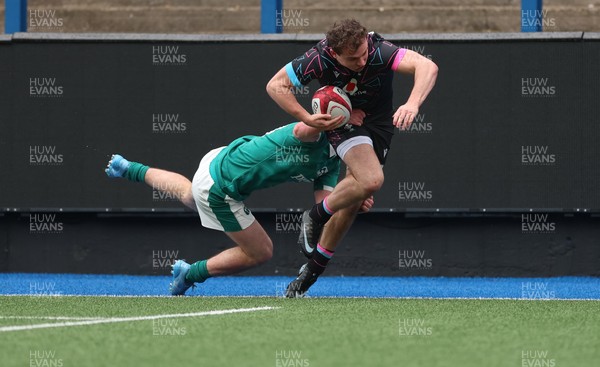 290326 - Wales U19 v Ireland U19 - Rhys Cole of Wales is tackled into touch by Fionn Rowsome of Ireland