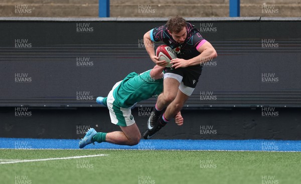 290326 - Wales U19 v Ireland U19 - Rhys Cole of Wales is tackled into touch by Fionn Rowsome of Ireland