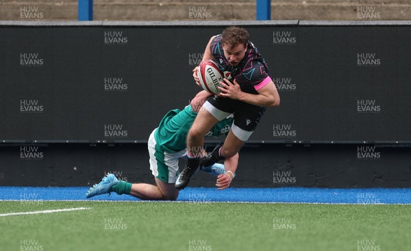 290326 - Wales U19 v Ireland U19 - Rhys Cole of Wales is tackled into touch by Fionn Rowsome of Ireland