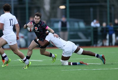 191225 - Wales U19s v England U19s - International Friendly - Carwyn Leggatt-Jones of Wales is tackled by Tate Williams of England 