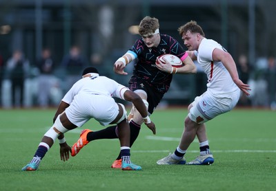 191225 - Wales U19s v England U19s - International Friendly - Osian Williams of Wales is tackled by Tate Williams of England 